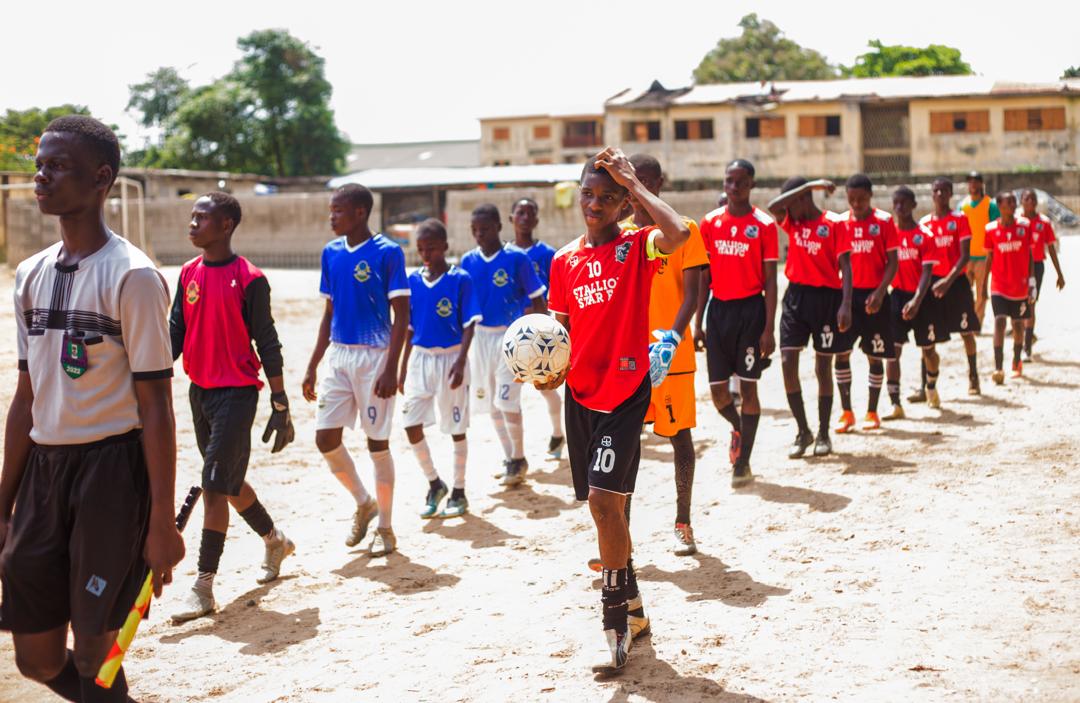 Young footballers walking onto the pitch before a match
